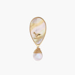 Iridescent shell brooch with gold bird accent and wire-wrapped baroque pearl drop on cream background.