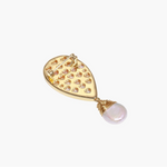 Iridescent shell brooch with gold bird accent and wire-wrapped baroque pearl drop on cream background.